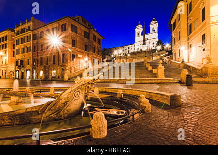 Historic spanish steps , church and boat shaped stone fountain in Rome, Italy, at sunrise. Stock Photo