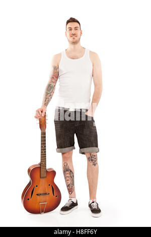 Young tattooed man with his guitar. Stock Photo