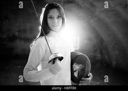 Indoor portrait of a young fencing professional. Stock Photo