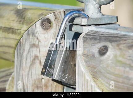 Abloy padlock attached to a wooden gate. Stock Photo