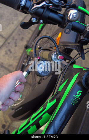 MTB shock pump being used on a Scott Scale 950 Cycle - attach pump Stock Photo