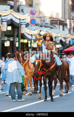 Kyoto, Japan. Men in traditional dress on horseback during Gion Matsuri festival. Stock Photo