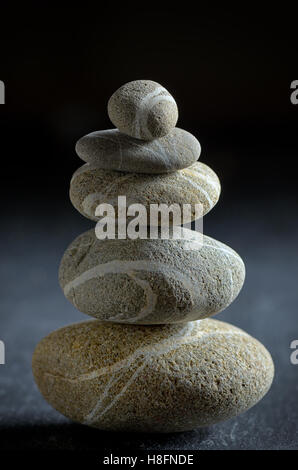 stack of  pebble stones on black background Stock Photo