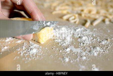 Woman's hands knead dough pasta Stock Photo