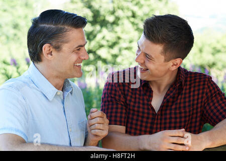 Father Talking To Adult Son Outdoors Stock Photo