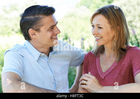 Smiling Mature Couple Talking To One Another Outdoors Stock Photo