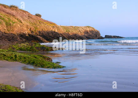 Low tide in a sandy cove at Inchydoney beach in County Cork on the South Coast of Ireland reveals the ripples in the sand Stock Photo