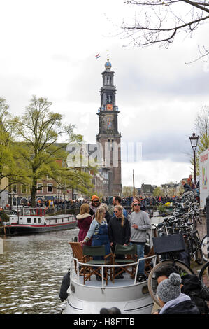 People along the canals celebrating the King's Birthday in Amsterdam, Holland, Netherlands. Stock Photo