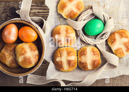 Homemade Easter hot cross buns and eggs on wooden table, top view Stock Photo