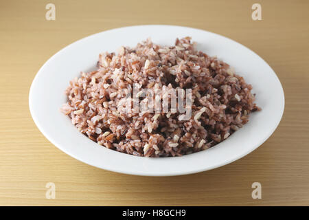 Cooked brown thai rice berry or brown jasmine rice in white dish,concept of meal healthy and clean food for Lose weight. Stock Photo