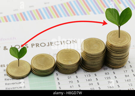 silver coin stack and arrow line and have treetop in business growth concept on paper of report assessed income. Stock Photo