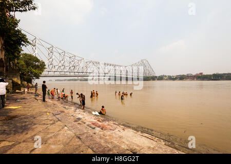 KOLKATA, INDIA - 22 Oct 2016: People bathe in the Hooghly River near Howrah Bridge on October 22, 2016 in Kolkata (Calcutta), In Stock Photo