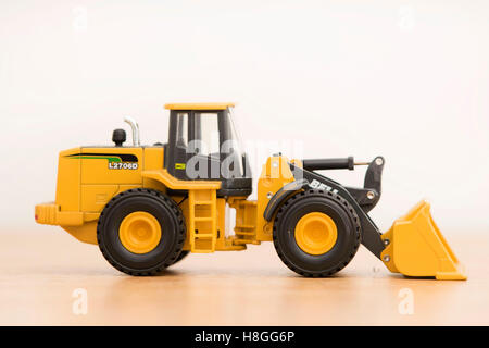 A small plastic toy digger. Stock Photo