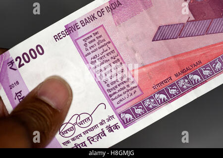 Ahmedabad, India. 12th Nov, 2016. An indian man holding the new 2000 Rupee Currency note put into circulation all over India. The old 500 and 1000 Rupee notes demonetised leading to long queues outside  banks to exchange and deposit the demonitised notes Credit:  manjeet & yograj jadeja/Alamy Live News Stock Photo