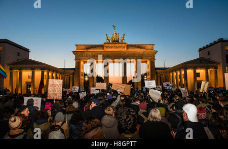 Berlin, Germany. 12th Nov, 2016. Demonstrators stand during a protest rally against US President-elect Donald Trump on Pariser Platz outside the American Embassy in Berlin, Germany, 12 November 2016. The Brandenburg Gate can be seen in the background. Photo: GREGOR FISCHER/dpa/Alamy Live News Stock Photo