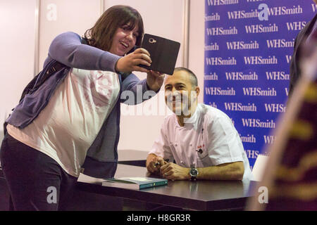 London,UK.12th November 2016. Michel Roux Jr.  poses for a selfie with a fan during his book signing session at the BBC Good Food Show at Olympia London. Michel Roux Jr. is a British two stars Michelin chef. Credit:  Laura De Meo/ Alamy Live News Stock Photo