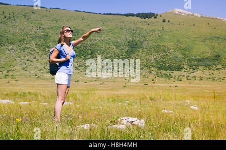 Young woman in nature exploring enjoying beautiful surrounding Stock Photo