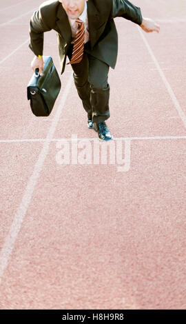 Businessman on running track Stock Photo