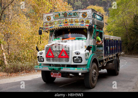 Decorated colourful heavy goods lorry TATA in mountain road, Bhutan, South Asia Stock Photo