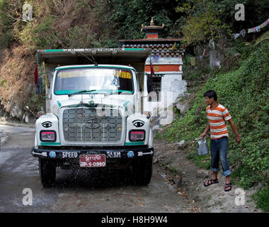 Decorated colourful heavy goods lorry TATA in mountain road, Bhutan, South Asia Stock Photo