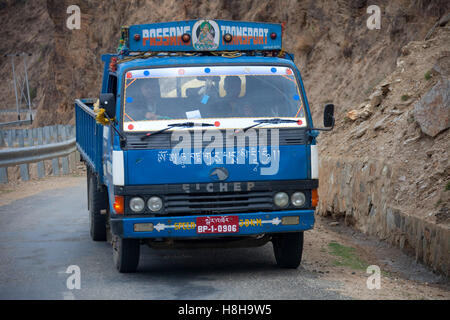 Decorated colourful heavy goods lorry TATA in mountain road, Bhutan, South Asia Stock Photo