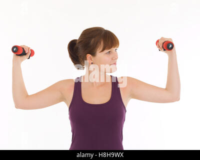 Young woman training with dumbbells Stock Photo