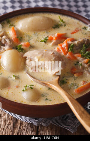 Belgian Ghent waterzooi soup with chicken close up in a bowl. Vertical Stock Photo