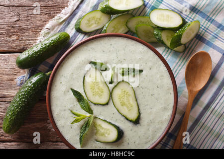 Soup of fresh cucumbers with yogurt close up in a bowl on the table. Horizontal view from above Stock Photo