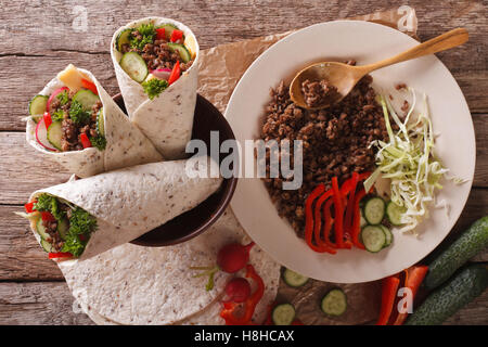 Sandwich roll stuffed with beef and vegetables close-up on the table. horizontal view from above Stock Photo