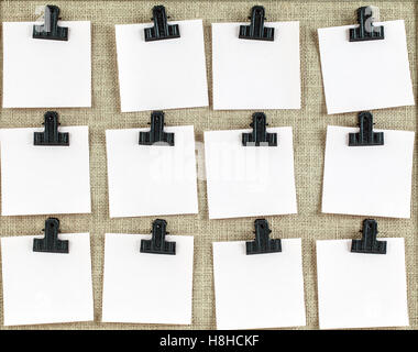 Notice board with twelve clips and blank note paper. Empty space for more text on each square. Stock Photo