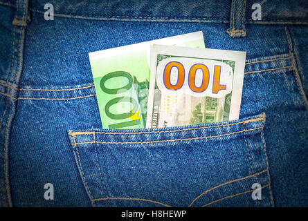 Blue jeans pocket with one hundred euro and one hundred american dollar Stock Photo