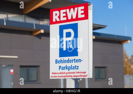 BURG / GERMANY - NOVEMBER 13, 2016: handicapped parking (Behindertenparkplatz) sign on parking area from supermarket REWE.
