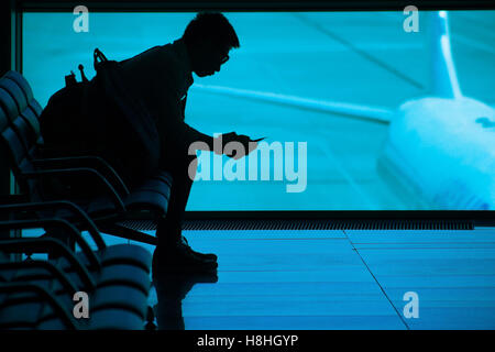Passenger waiting at airport silhouette Stock Photo
