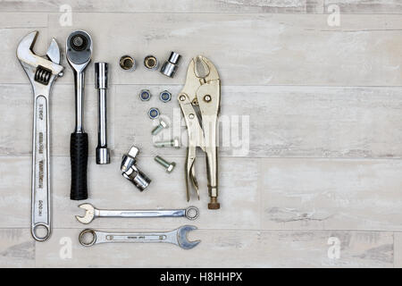 Selection of hand wrenches, sockets, spanners and vice grips on a shabby style wood floor Stock Photo