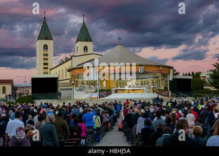 MEDJUGORJE, BOSNIA AND HERZEGOVINA, October 04 2016. Thousands of pilgrims attending a holy mass/service in the evening. Dramati Stock Photo