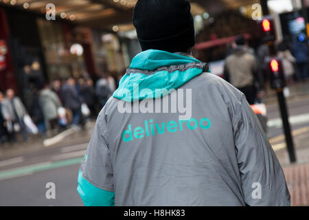 Deliveroo personnel in the Central Business District of Market Street, Manchester, UK Stock Photo