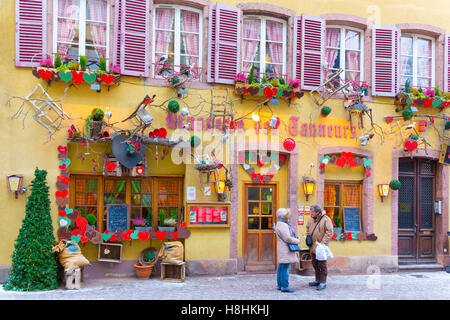 Christmas decorations on typical historic half-timbered restaurant, in the center of Colmar, wine route, Alsace, France Stock Photo