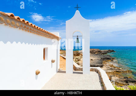 Agios Nikolaos. Small white Orthodox bell tower arch near church. Coast of island Zakynthos, Greece Stock Photo