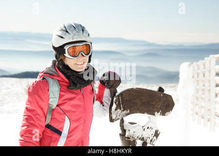 Young woman skier at winter ski resort in mountains Stock Photo