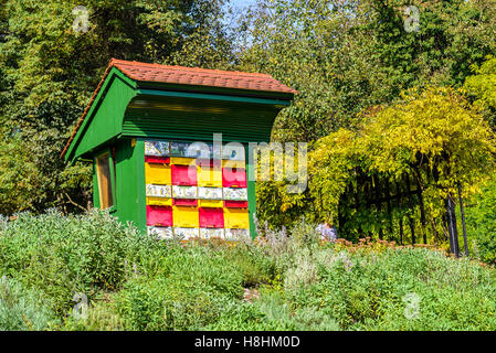 Traditional colorful and picturesque wooden bee hives in Slovenia. The hives are brightly painted to allow the bees find their h Stock Photo