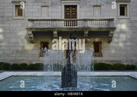 The iconic Frederick MacMonnies' Bacchante and Infant Faun statue and fountain in the McKim Building Courtyard. Stock Photo