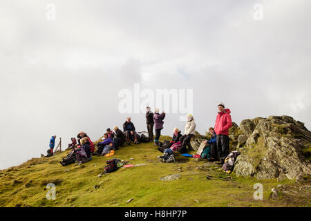 Group of hikers resting on Yr Aran summit in Snowdonia National Park. Gwynedd, Wales, UK, Britain