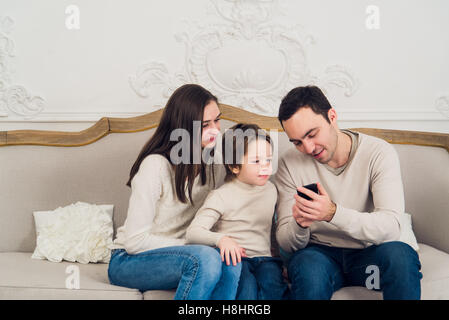 Family playing video game on smart phone Stock Photo