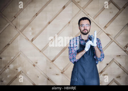 Portrait of a carpenter working in workshop wearing gloves Stock Photo