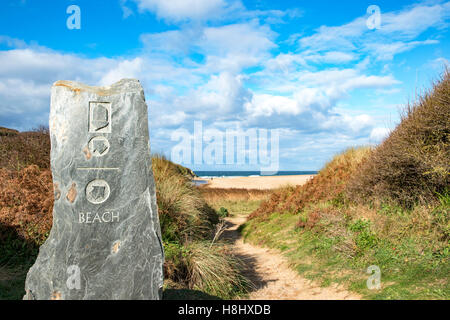 a direction sign and footpath to the beach at Holywell bay in Cornwall, England, UK Stock Photo
