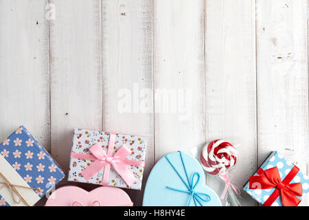 Christmas gift boxes with different patterns on white wooden background Stock Photo