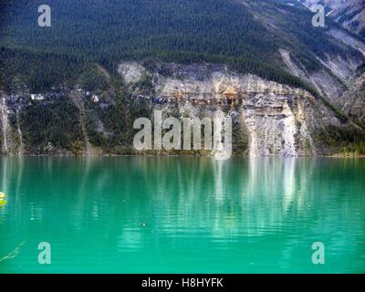 Rocky Mountainside Reflecting in Muncho Lake, British Columbia, Canada Stock Photo