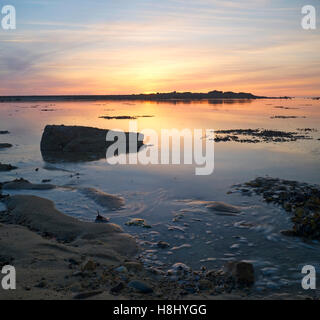 Sunset over calm waters at Sillon de Talbert, Brittany Stock Photo