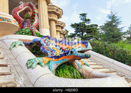 Park Guell in Barcelona. Frog sculture fountain at main entrance covered with pieces of colorful ceramic tile Stock Photo