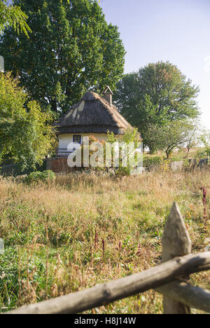 Old village house is located in autumn garden Stock Photo